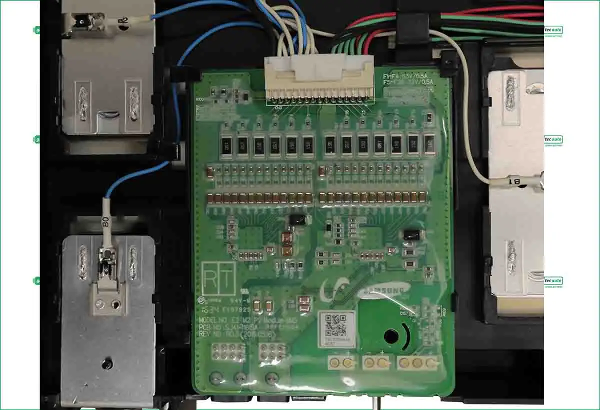 Green control PCB inside an electrical panel with terminal blocks, blue wires, and a white connector at the top; left shows a metal power module, right a silver module.