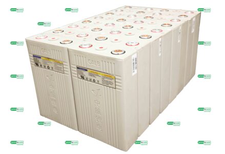 Row of large industrial battery bank with multiple cells and red/metal terminals, surrounded by GreenTec Auto logos (watermarks).