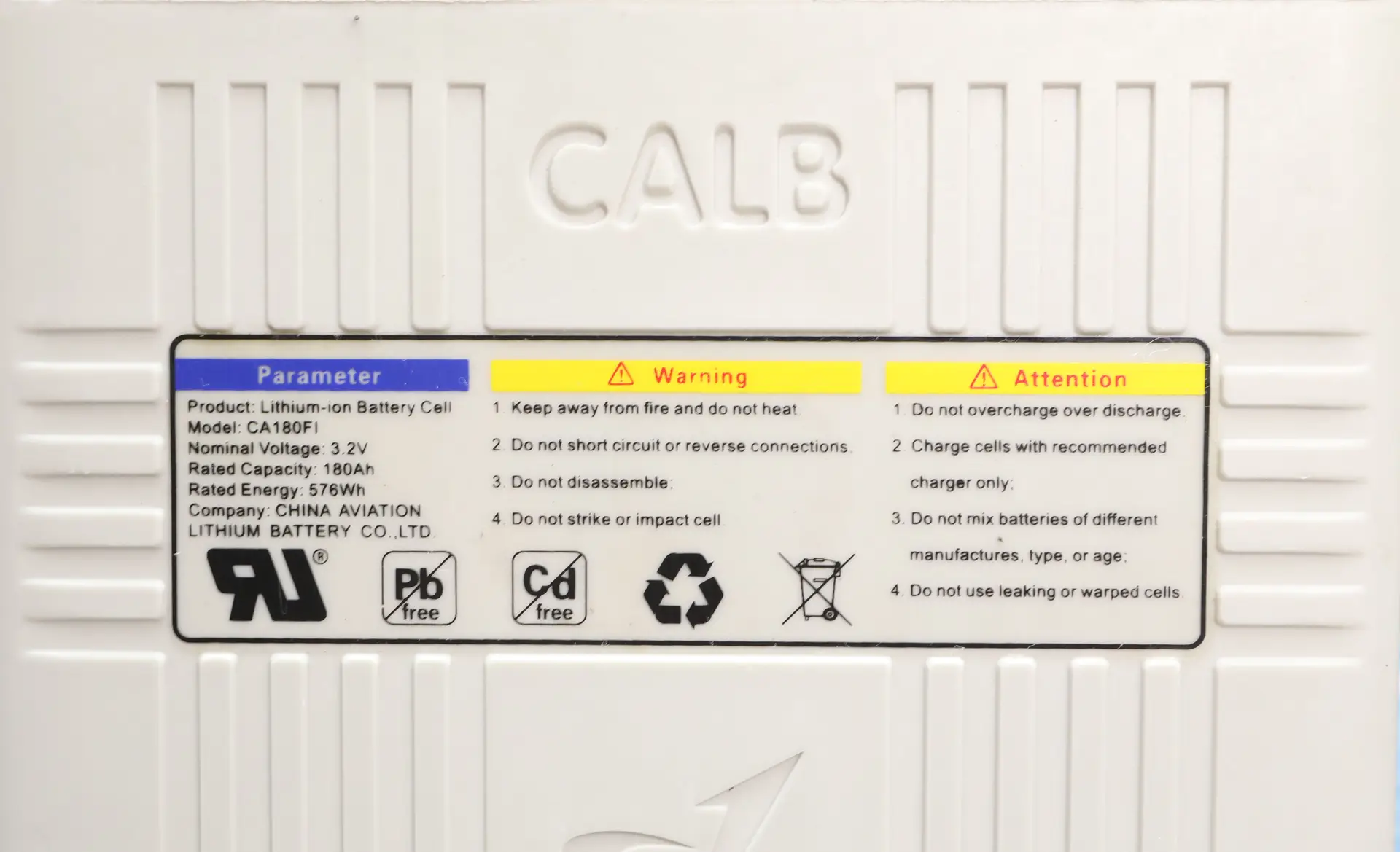 White battery casing with embossed CALB logo and a colored label showing 'Parameter' and 'Warning/Attention' sections and safety text.