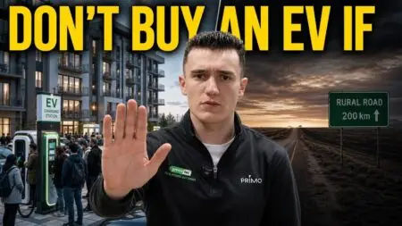 Man in a black PRIMO jacket holds up his hand in a stop gesture, with an EV charging station and a crowd of people on the left and a rural road sign on the right under a dramatic sky. The large yellow text at the top reads “DON'T BUY AN EV IF.”