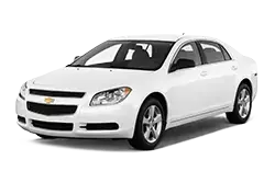 White four-door sedan shown from a front-right angle (car facing left).
