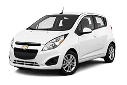 White Chevrolet small taxi car with rooftop light, shown in a front three-quarter view.