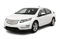 White sedan taxi with a rooftop light, facing left.