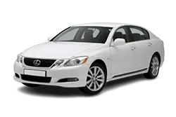 White mid-size sedan photographed from a front-side angle, showing a four-door car with alloy wheels.